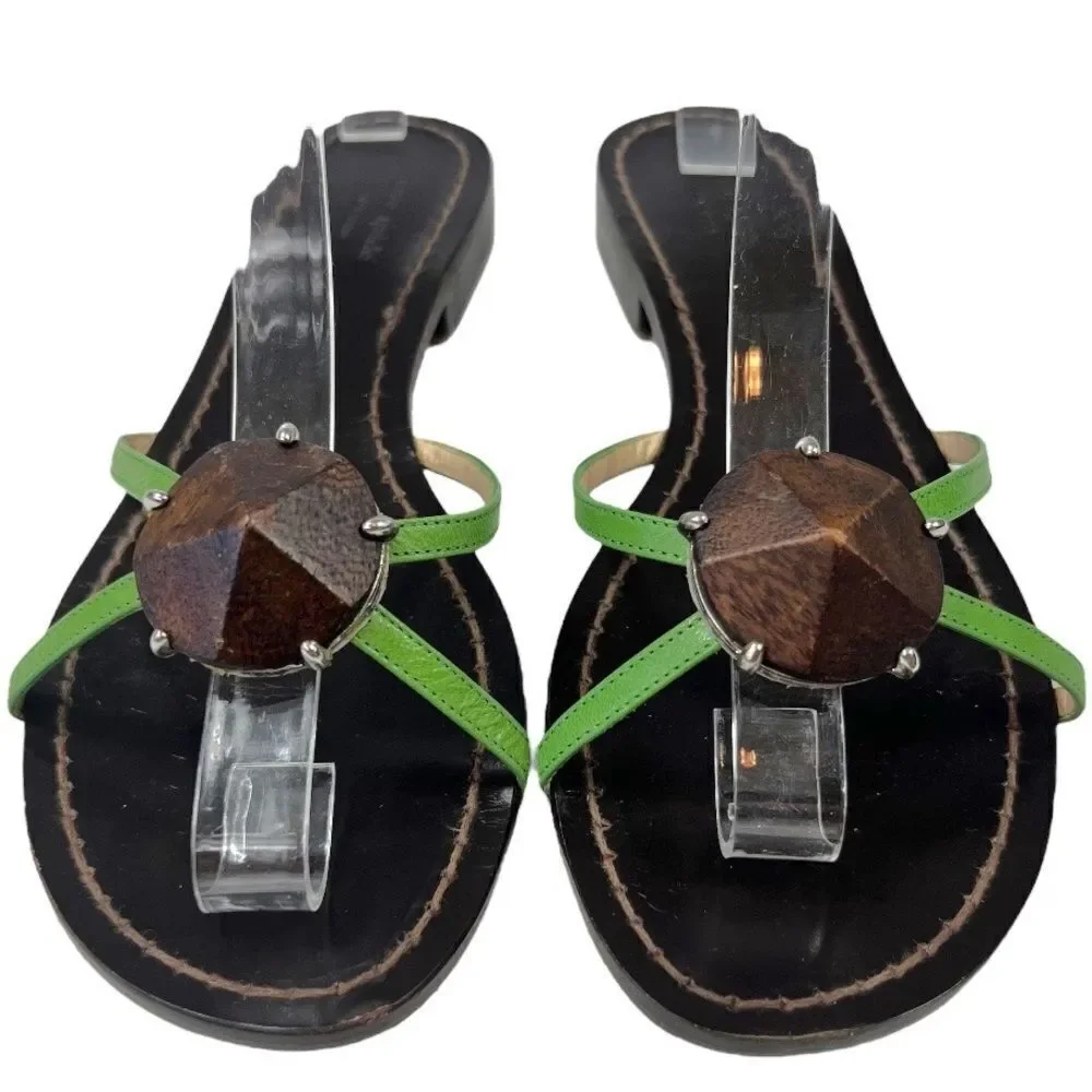 Kate Spade Green Leather Flat Sandals with wooden center ornament.